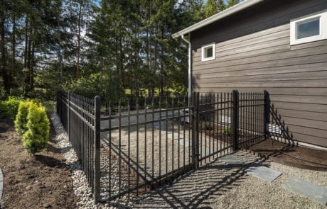 Black ornamental wrought iron residential fence installed by Summit Fence Co. LLC
