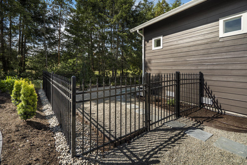 Black ornamental wrought iron residential fence installed by Summit Fence Co. LLC