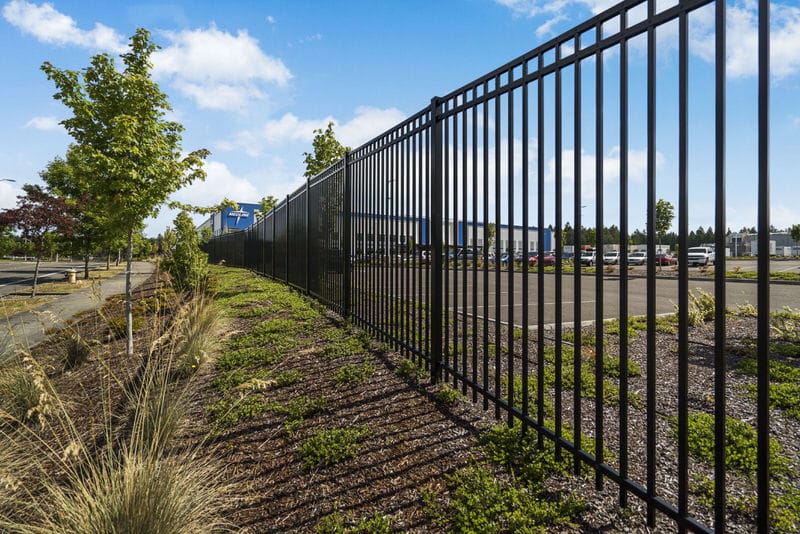 Black wrought iron security fence installed at Medline Industries distribution center in Lacey, WA by Summit Fence Co. LLC